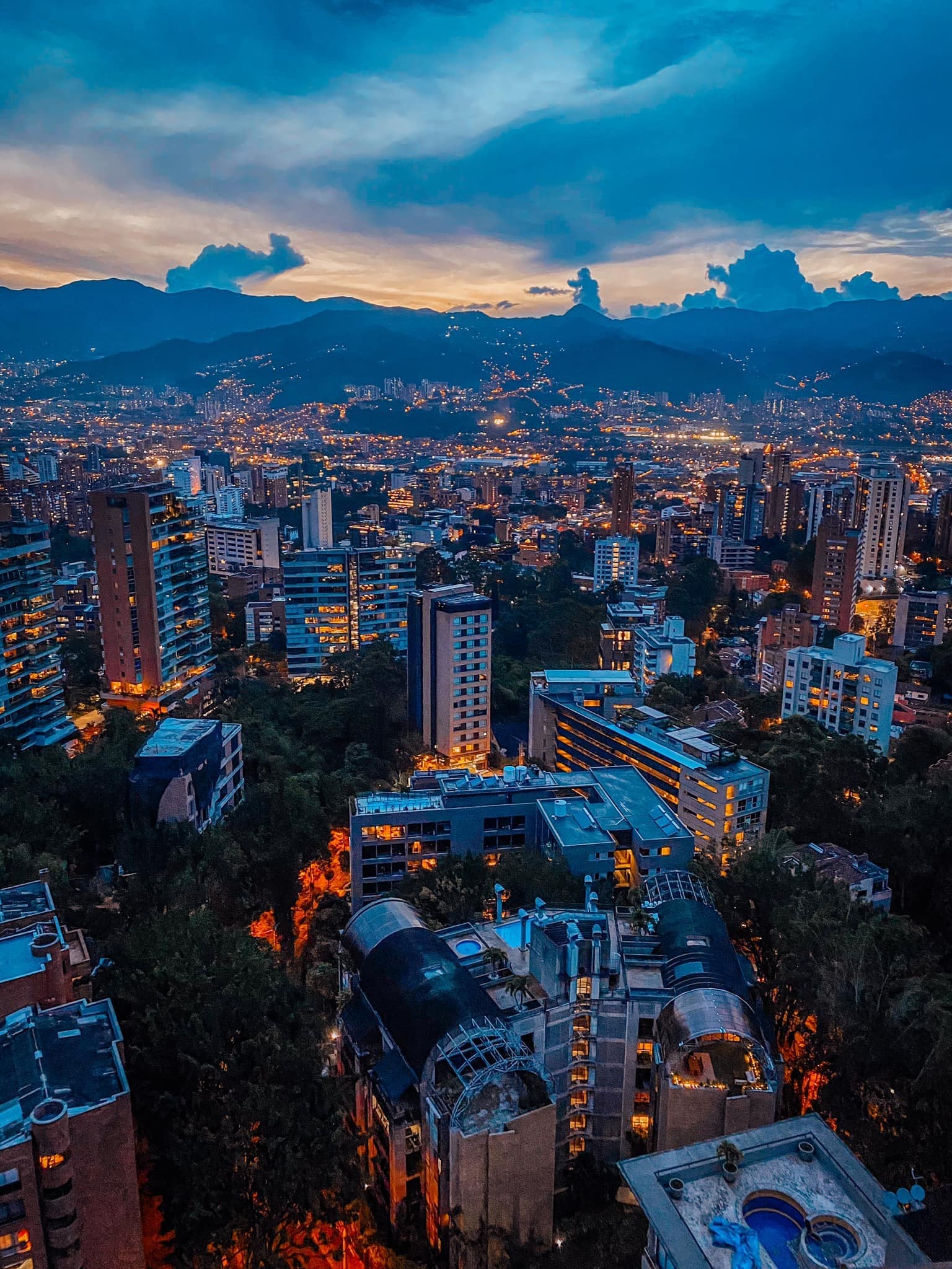 Medellín skyline at blue hour, ringed by the Andes